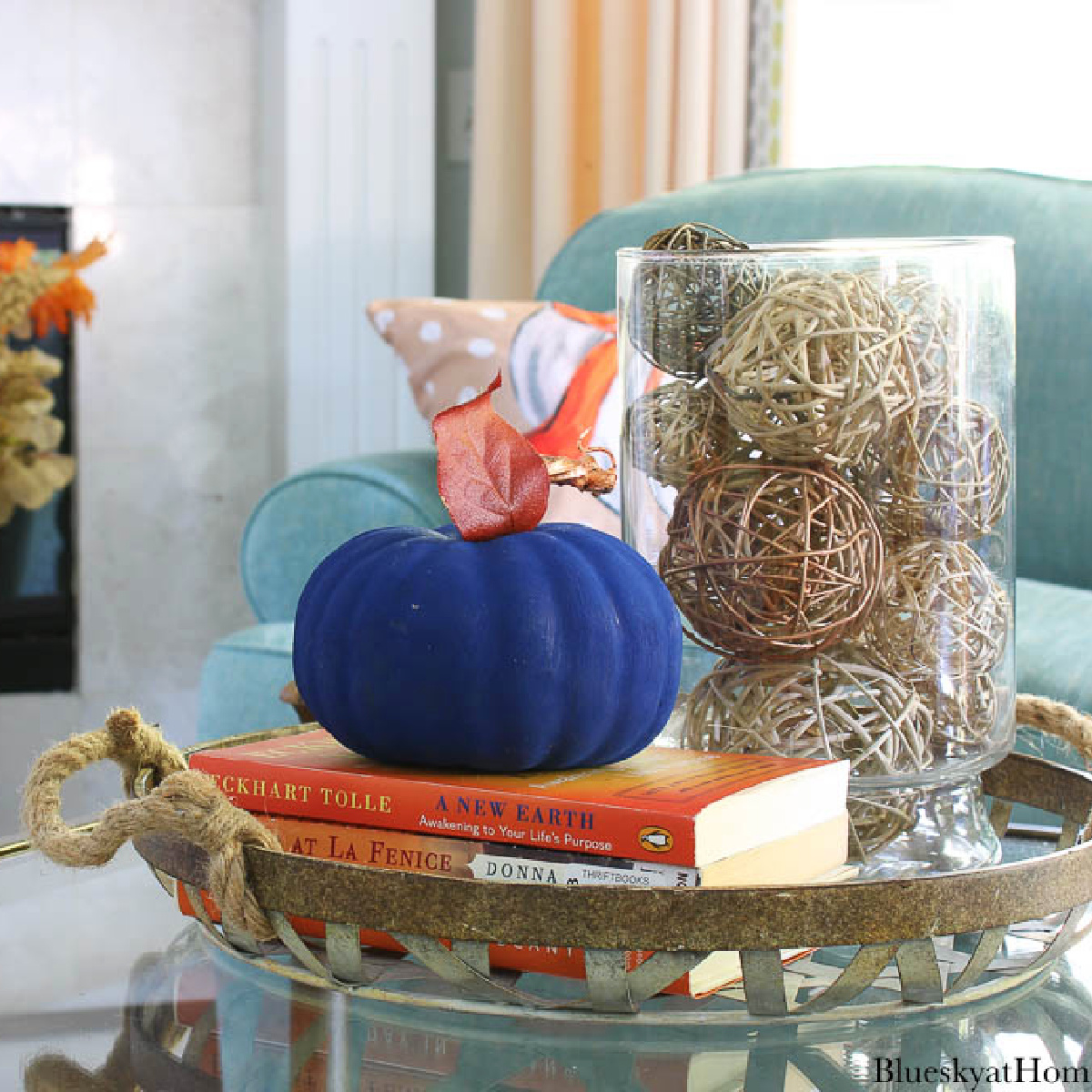 cozy fall living room decorated with blue painted pumpkin on a metal tray