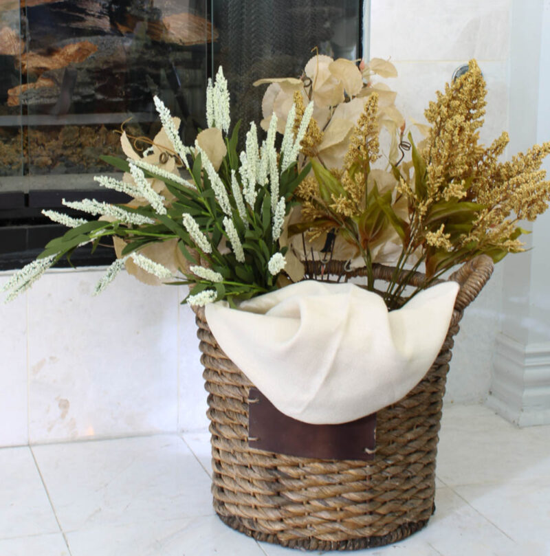 fall basket display on hearth in neutral flowers