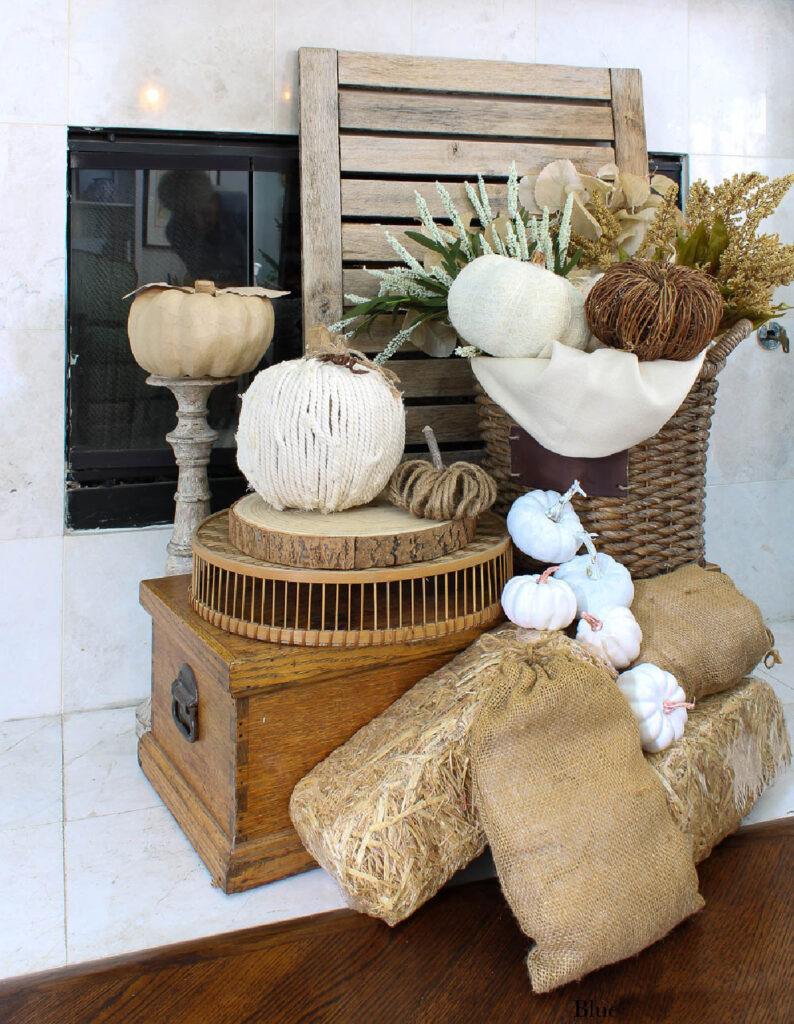 white yarn pumpkin on wood slice in fall basket display