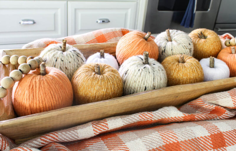 yarn pumpkins in dough bowl on kitchen island table