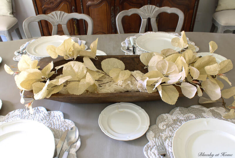 cream-colored faux fall foliage stems in dough bowl