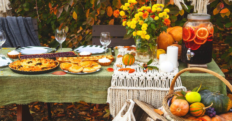 fall harvest party outdoors with flowers and pumpkins