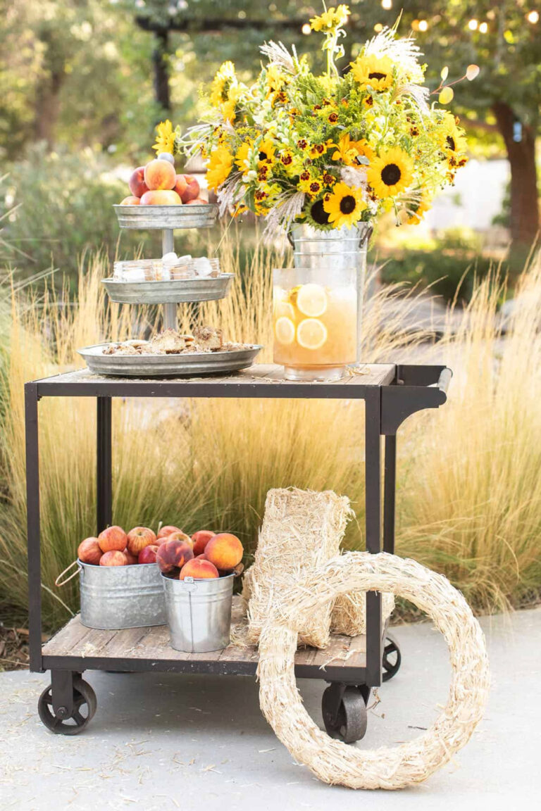 fall party with bar cart and pails of apples, straw wreath, and tiered tray