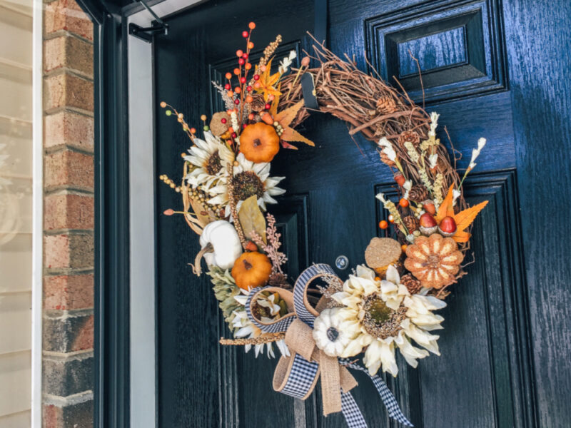 fall wreath grapevine with pumpkins and feathers and bows 
