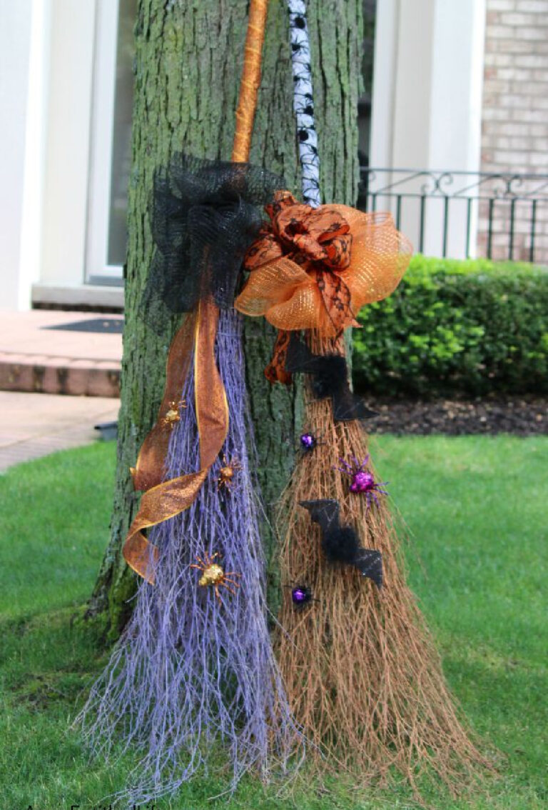 DIY glitter witches broomstick leaning on tree