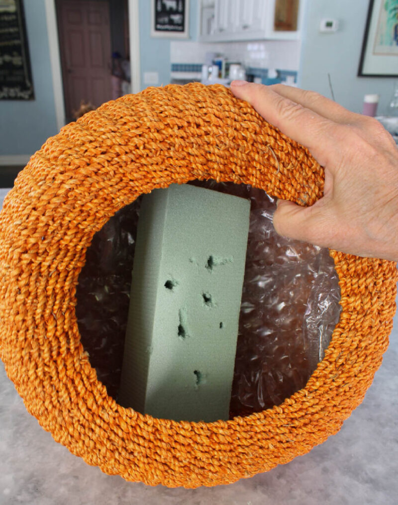 florist foam in woven orange pumpkin basket