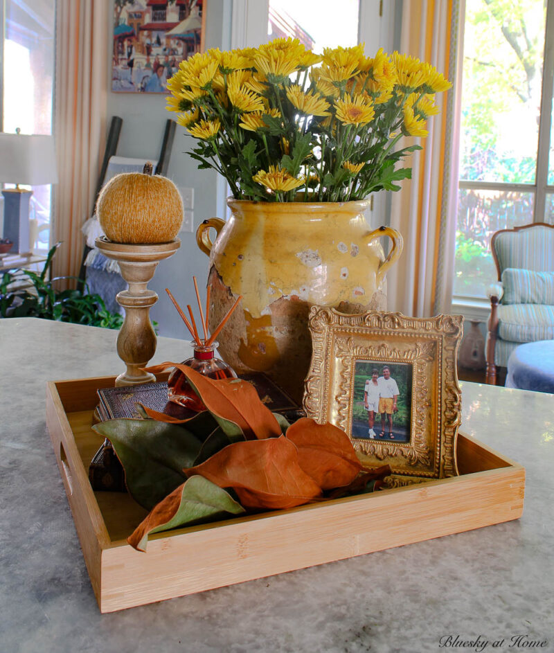 fall vignette with orange yarn pumpkin onwood candlestick 