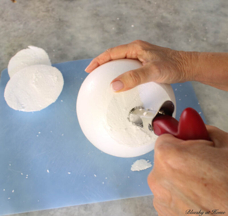 using apple corer to put hole in center of styrofoam ball