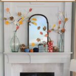 fall mantel decorated with DIY pumpkins and paper leaf trees