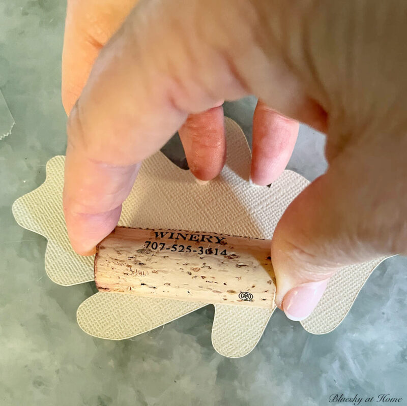 gluing wine cork to back of paper leaf