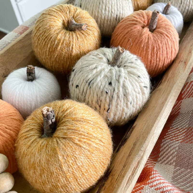 collection of pumpkins made with yarn in different colors