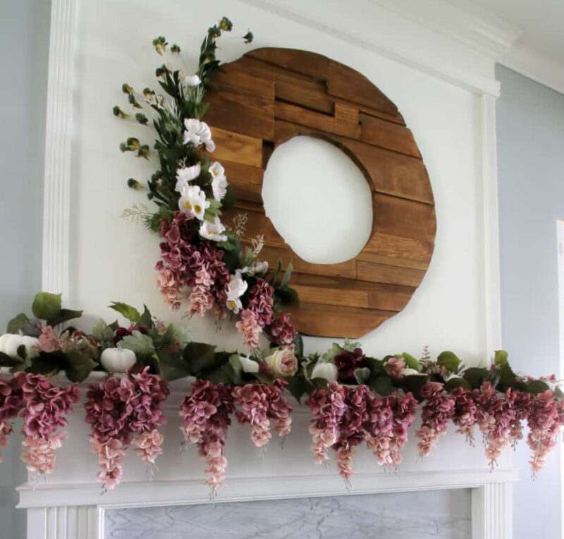 fall mantel styling with wood wreath and purple