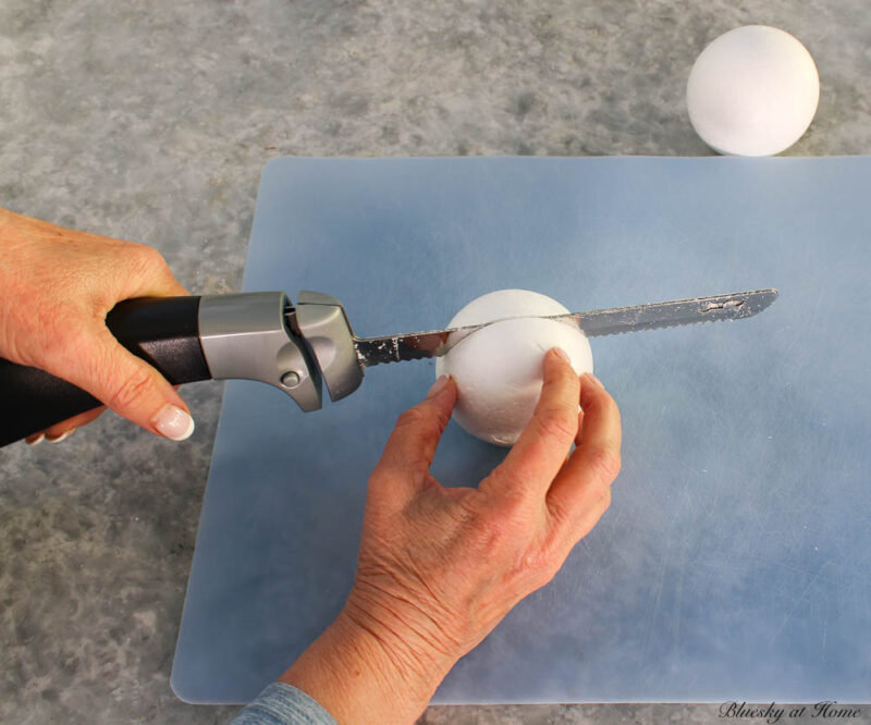 cutting styrofoam ball in half with electric knife