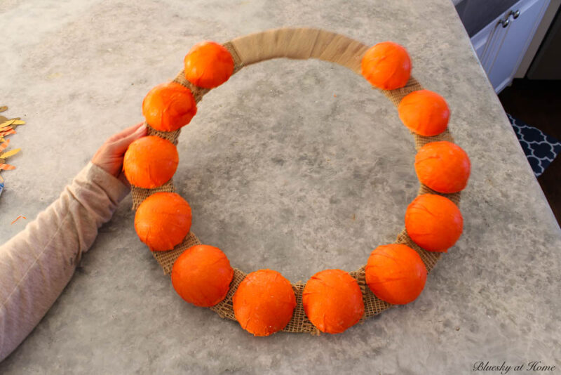 orange decoupaged balls on burlap wrapped wreath