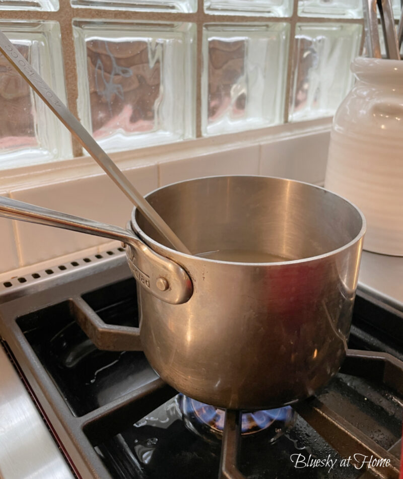 small saucepan with ladle on stove top