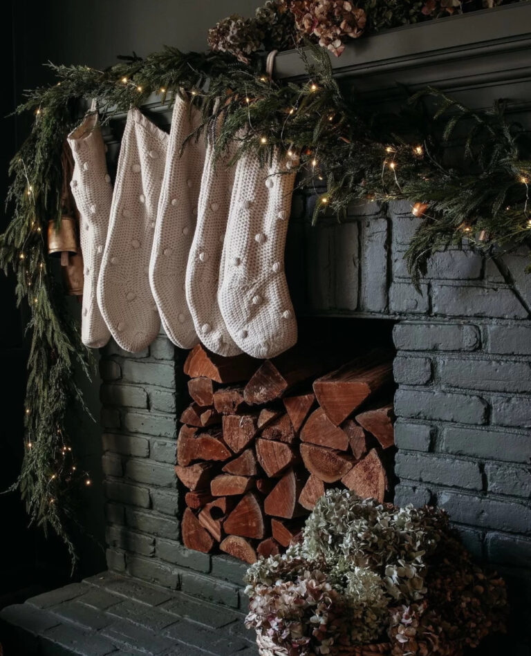 dark Christmas mantel with garland and stockings
