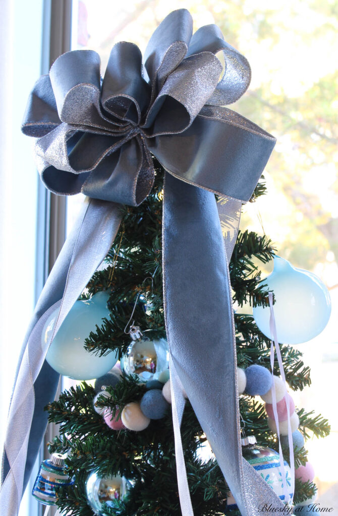 blue bow on tabletop Christmas tree