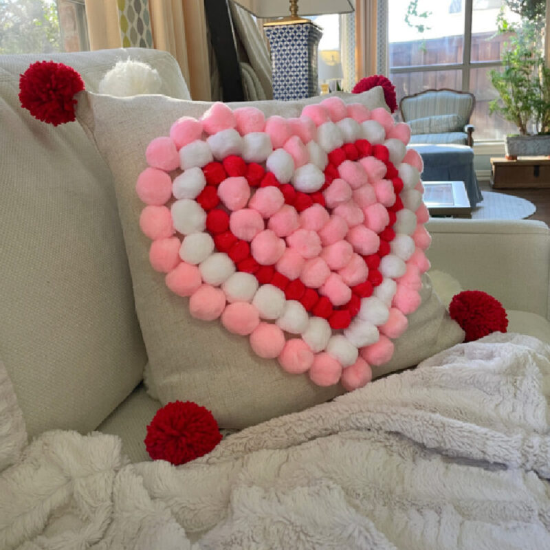 DIY Valentine pom-pom pillow on sofa