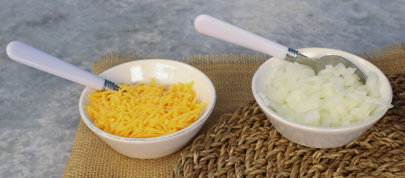 bowls of grated cheese and diced onion for chili recipe