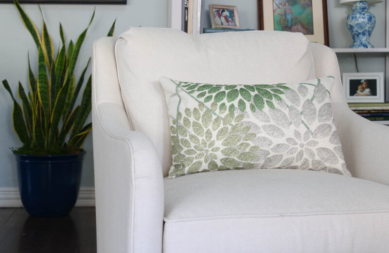green leaf pillow on white chair