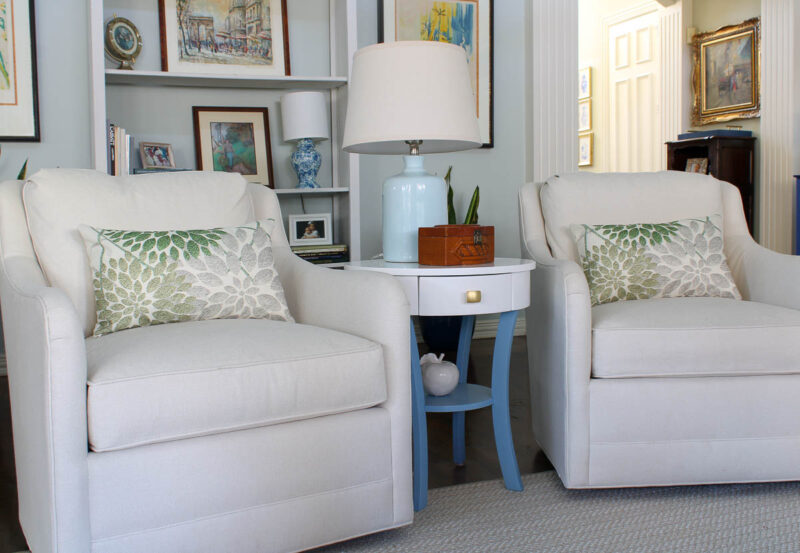 green leaf pillows on white chairs