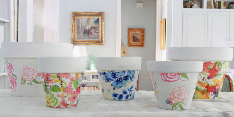 collection of 5 decoupage terra cotta pots in different colors and patterns