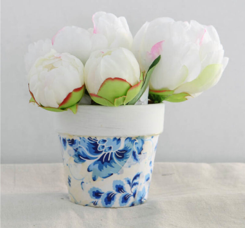 blue flowers on white background fabric decoupaged on white terra cotta pot