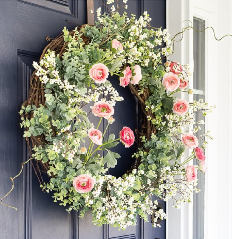 spring flower and greenery wreath on a blue front door