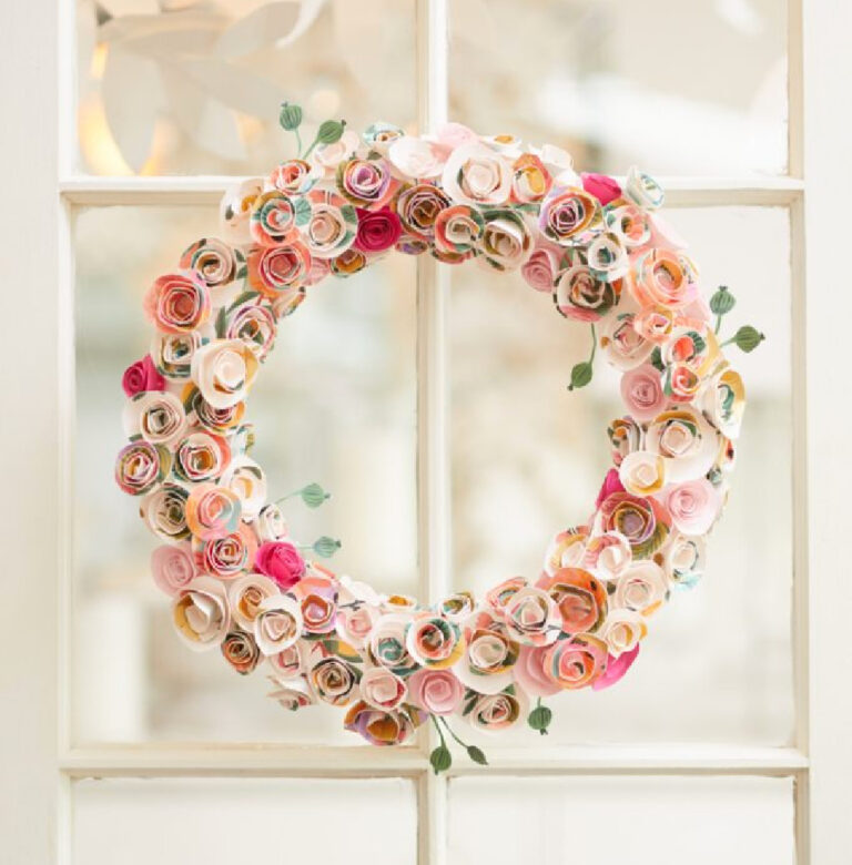 pretty pink paper flower spring wreath on glass paned window