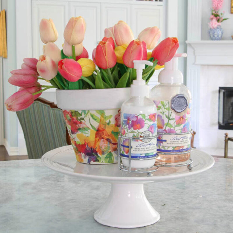 faux colorful tulips in floral pot on a cake stand