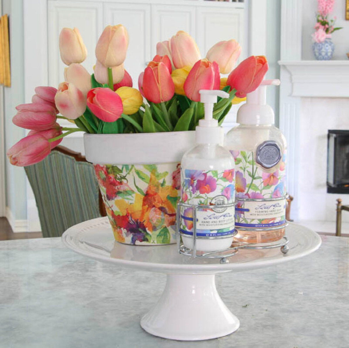 faux colorful tulips in floral pot on a cake stand