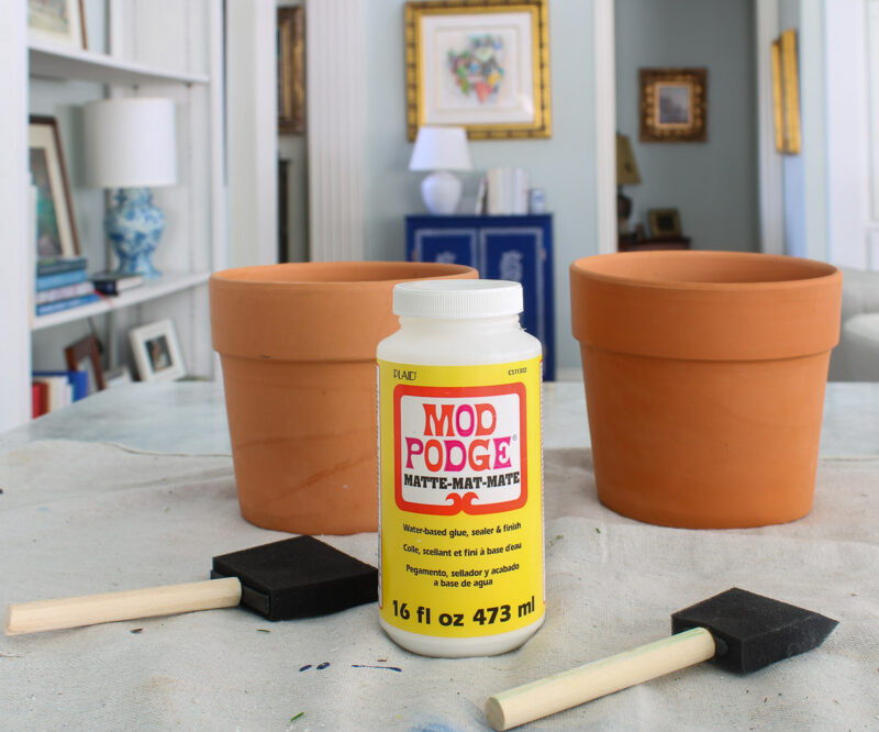 terra cotta planters with Mod Podge and foam brushes