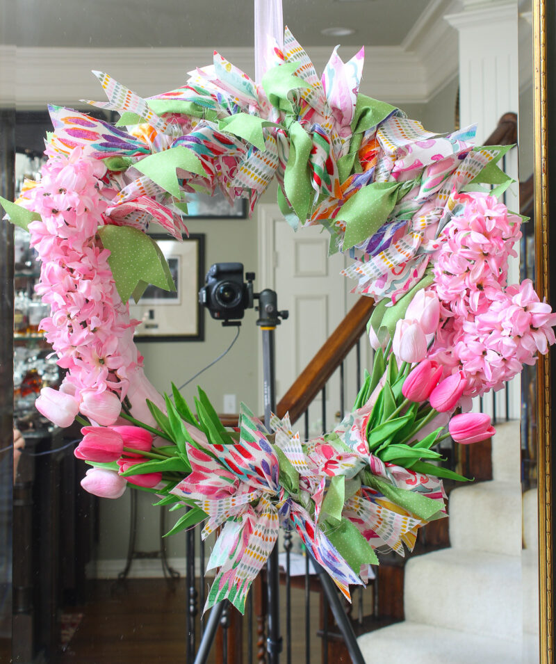 spring wreath with pink flowers and fabric hanging on mirror