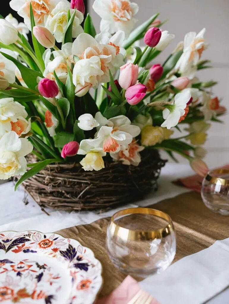 spring floral centerpiece of pink tulips in a twig nest.