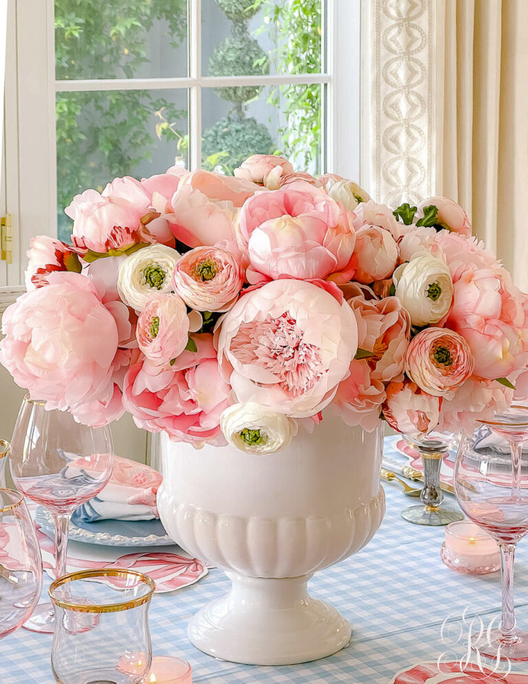 spring floral centerpiece with pale pink peonies and ranunculus.