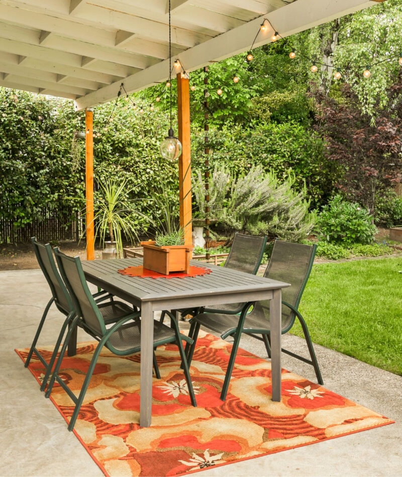 outdoor rug under dining table on patio