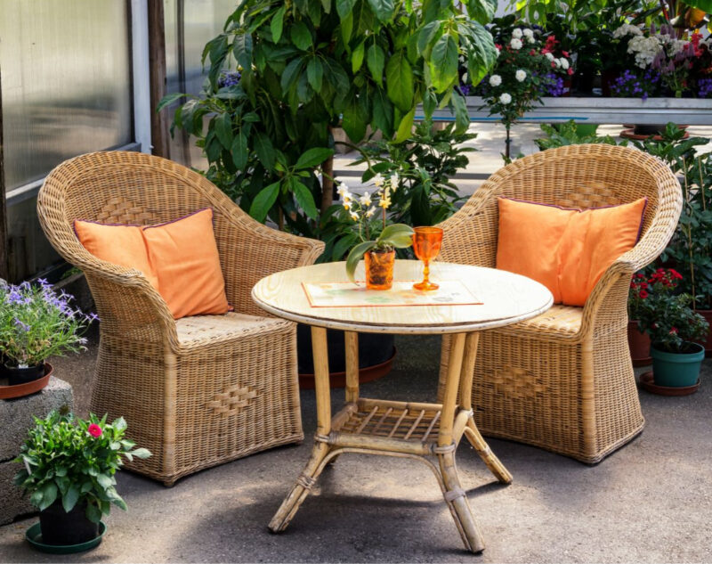 patio seating with orange pillows