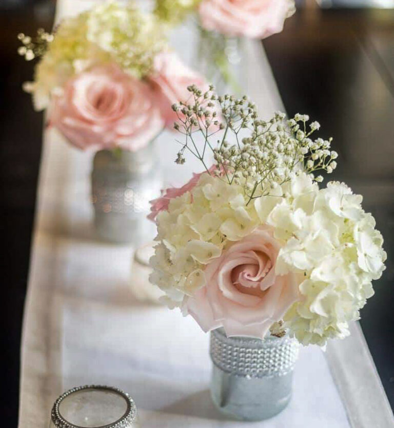 pale pink roses and white hydrangeas in glass jar