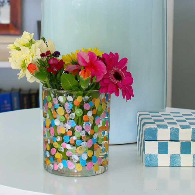 painted glass with metallic paint on table with blue lamp in background