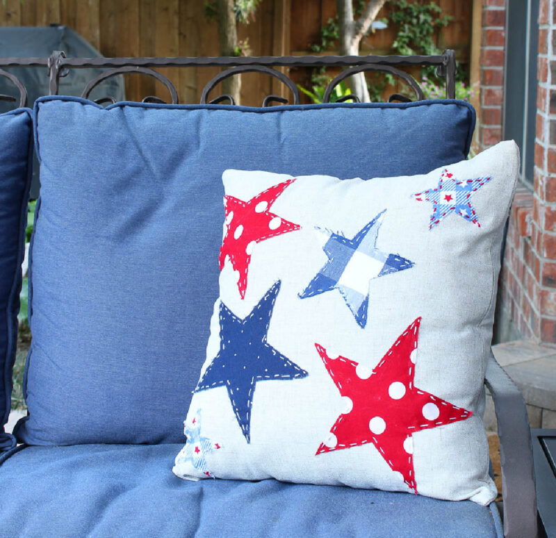 patriotic pillow on blue loveseat