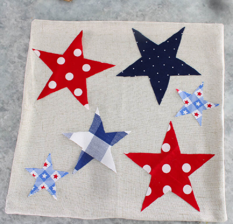red, white and blue stars on off white pillow