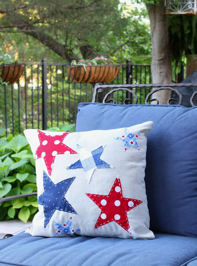patriotic star pillow on. blue loveseat