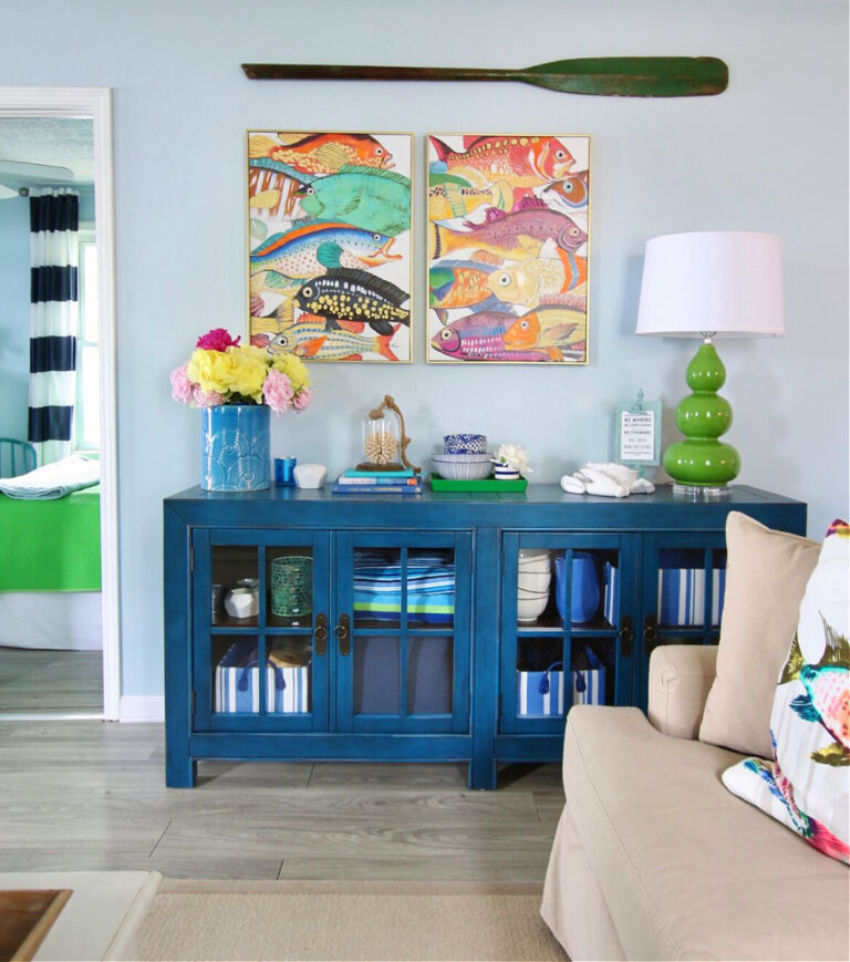 bright blue cabinet and colorful artwork