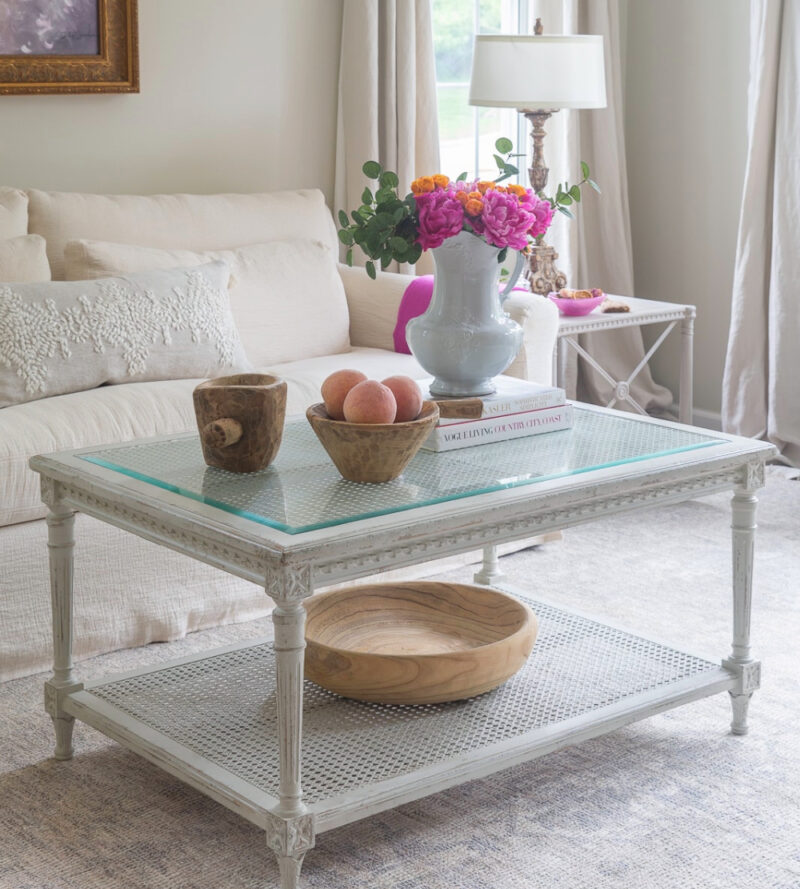 white summer living room with pink flwoers in white pitcher