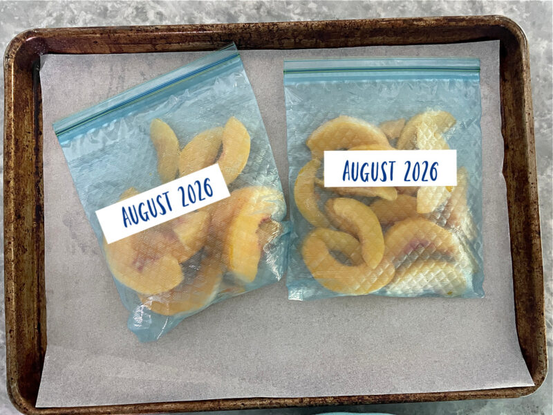 frozen peaches in labeled freezer bags
