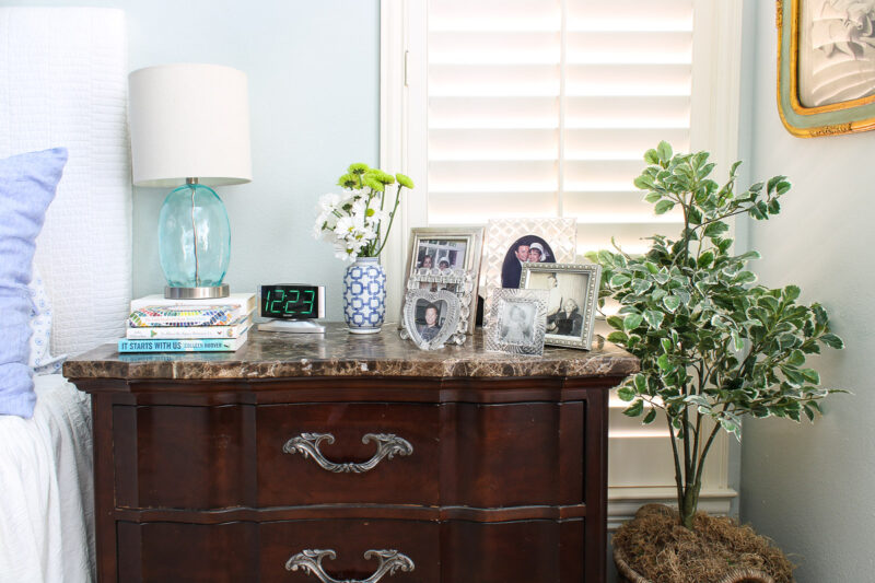 nightstand with fresh flowers and blue vase