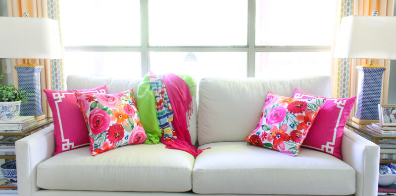 pink floral pillows on and solid pink pillows on white sofa