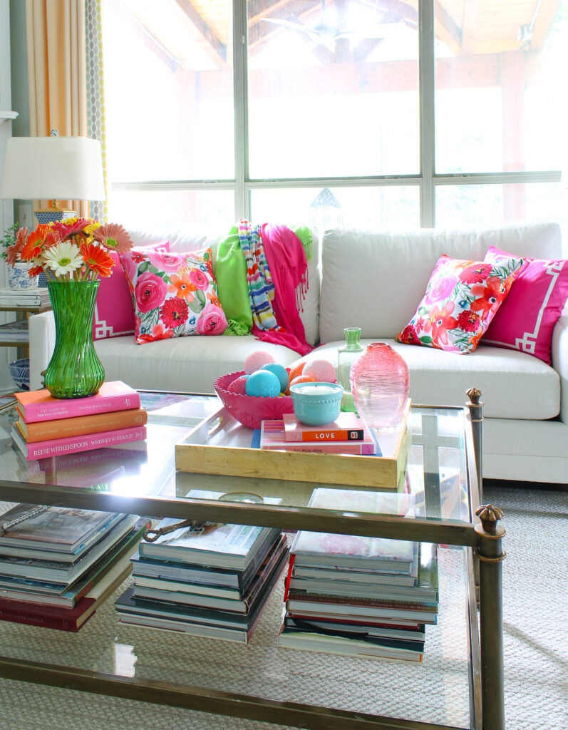 coffee table with colored vases and bright zinnia flowers