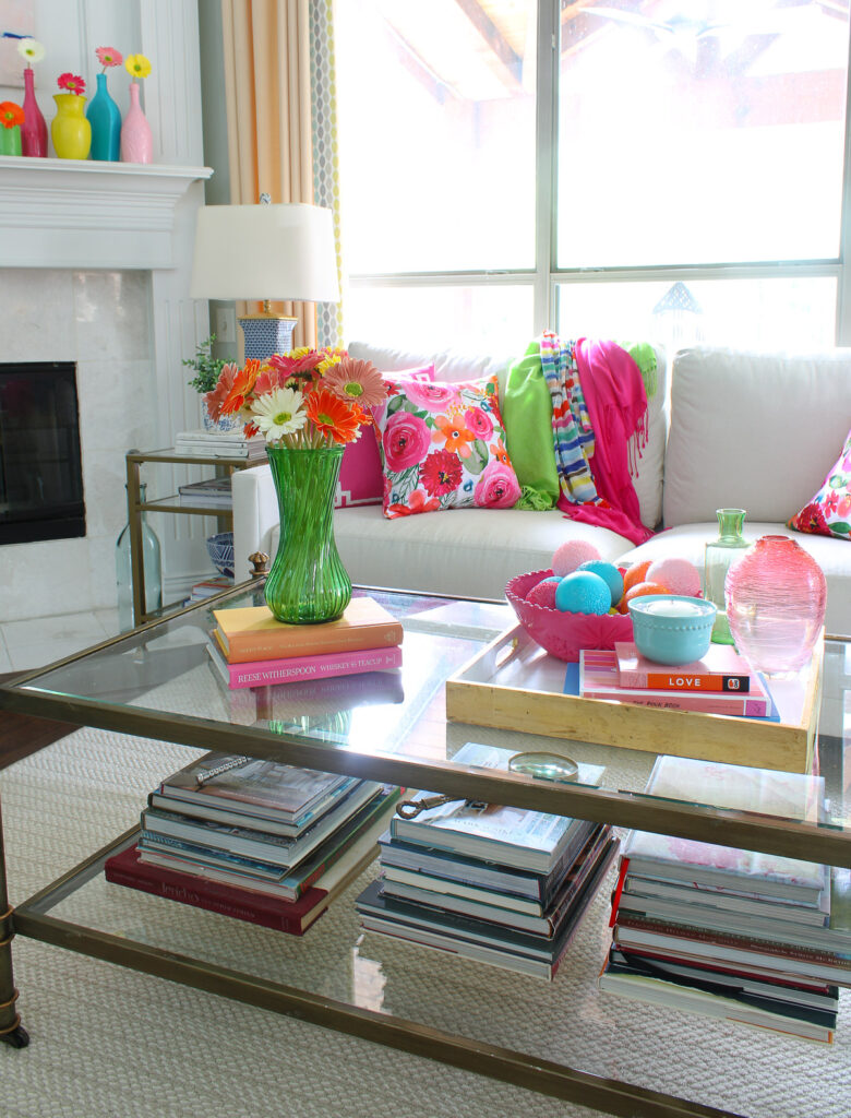 coffee table with colored vases and bright zinnia flowers