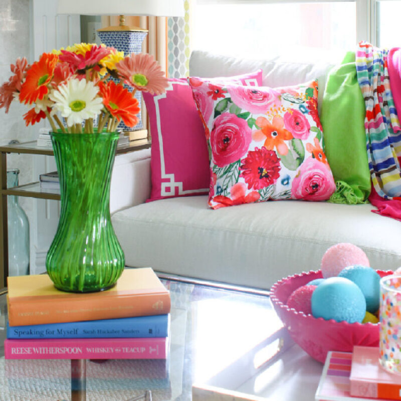 vibrant colors in summer decorating with pillows and flowers